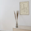 The Pen 04 art print inside a thin oak frame hanging on a white wall