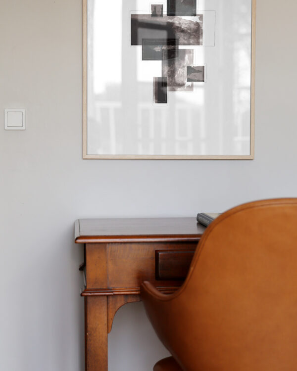 oak frame hanging on wall with an minimal art print inside