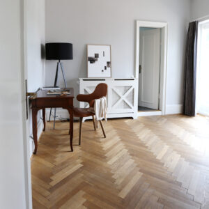 living room with a work desk with a chair and black frame with a black art print with the title Selected Blacks 04