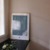 a frame with an art print with the title; Echo 02 standing on the kitchen table