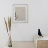 The art print: The Branch 01 hanging on a white wall in a oak frame